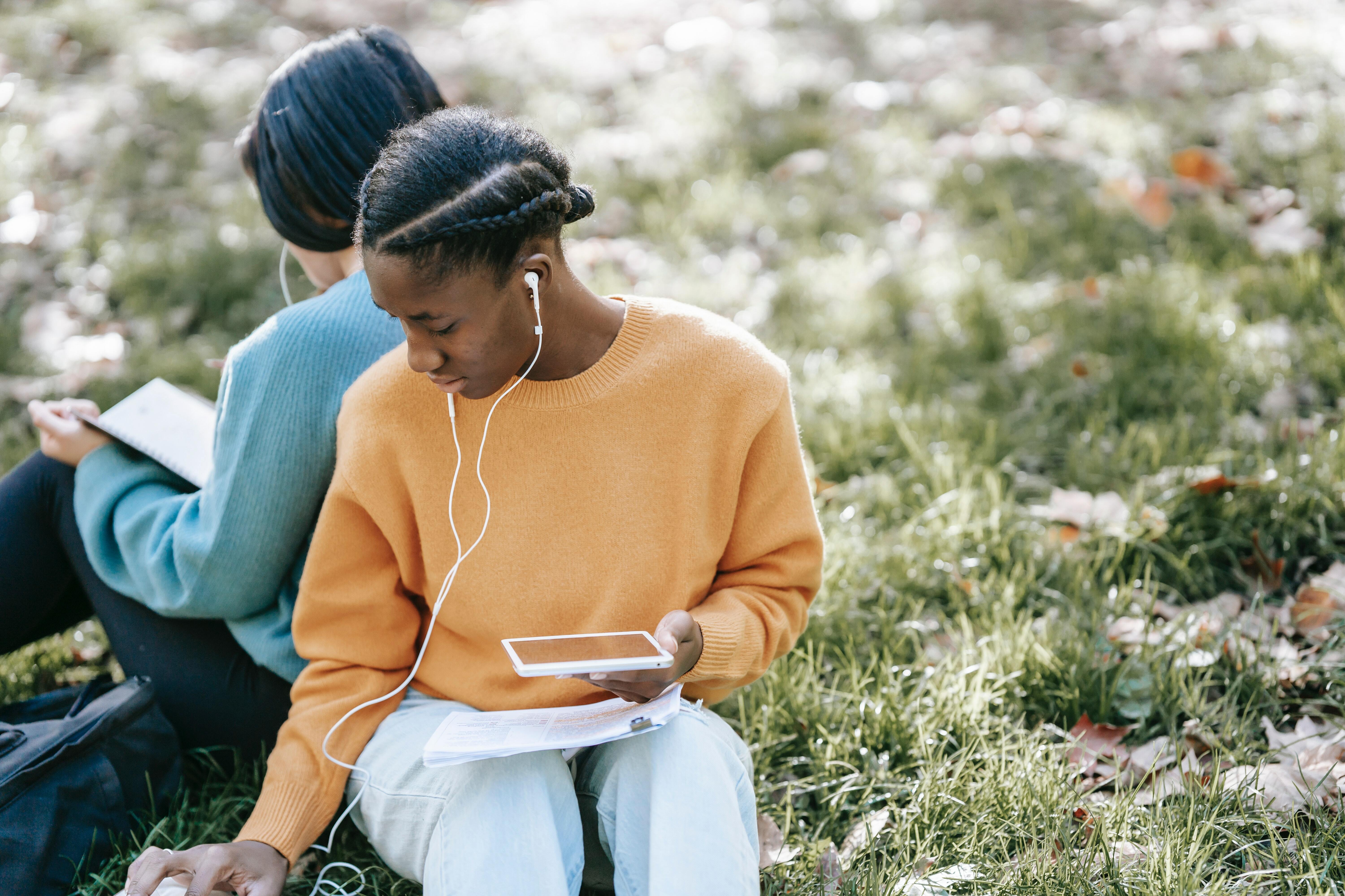 Two people listening to headphones