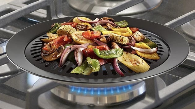 The Smokeless Non-Stick Indoor/Outdoor Grill cooking food.