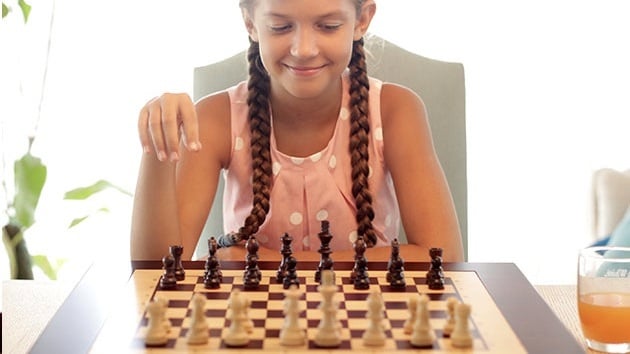 Child playing with the Square Off: World's Smartest Chessboard.