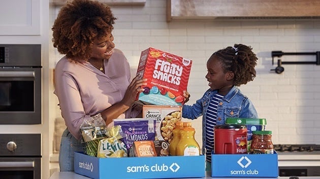 Mother and child unpacking groceries from the One-Year Sam’s Club Plus Membership.
