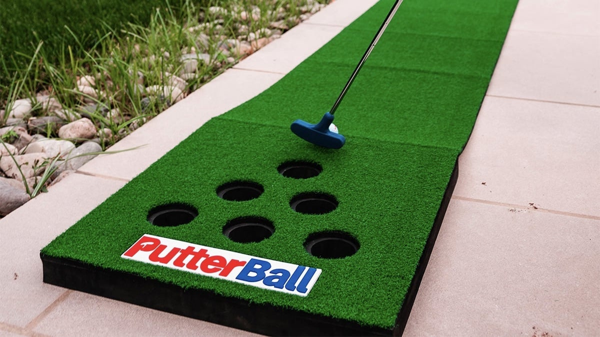 Person playing the PutterBall Backyard Golf Game.