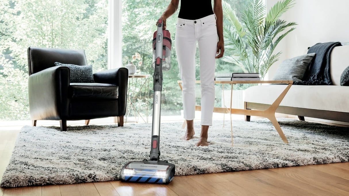 person vacuuming their living room