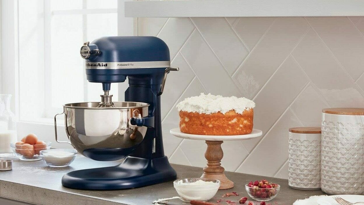 Blue kitchenaid mixer with cake on kitchen counter