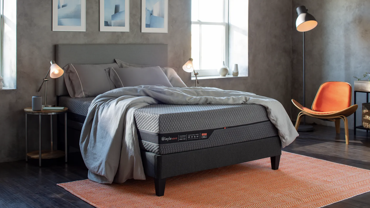 Layla Hybrid Mattress on bed frame with sheets and pillows