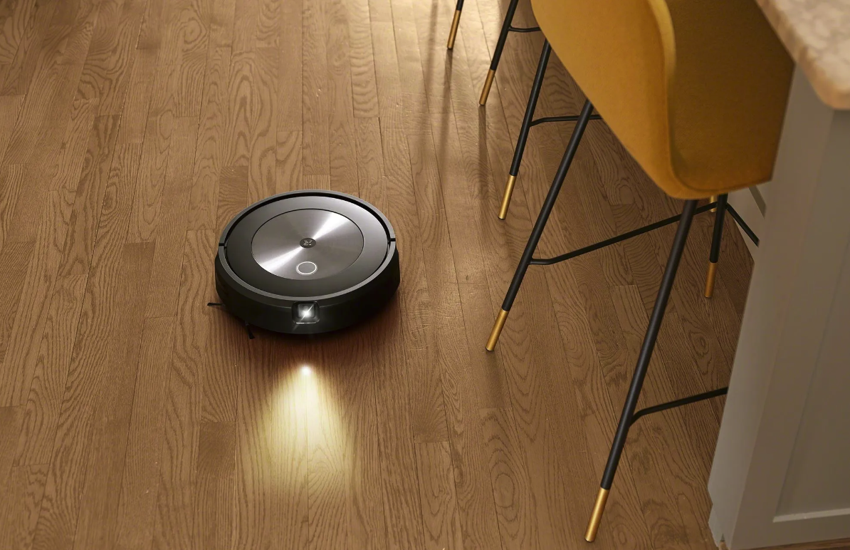 Roomba j7 robot vacuum cleaning hardwood floor with light to show obstacle camera