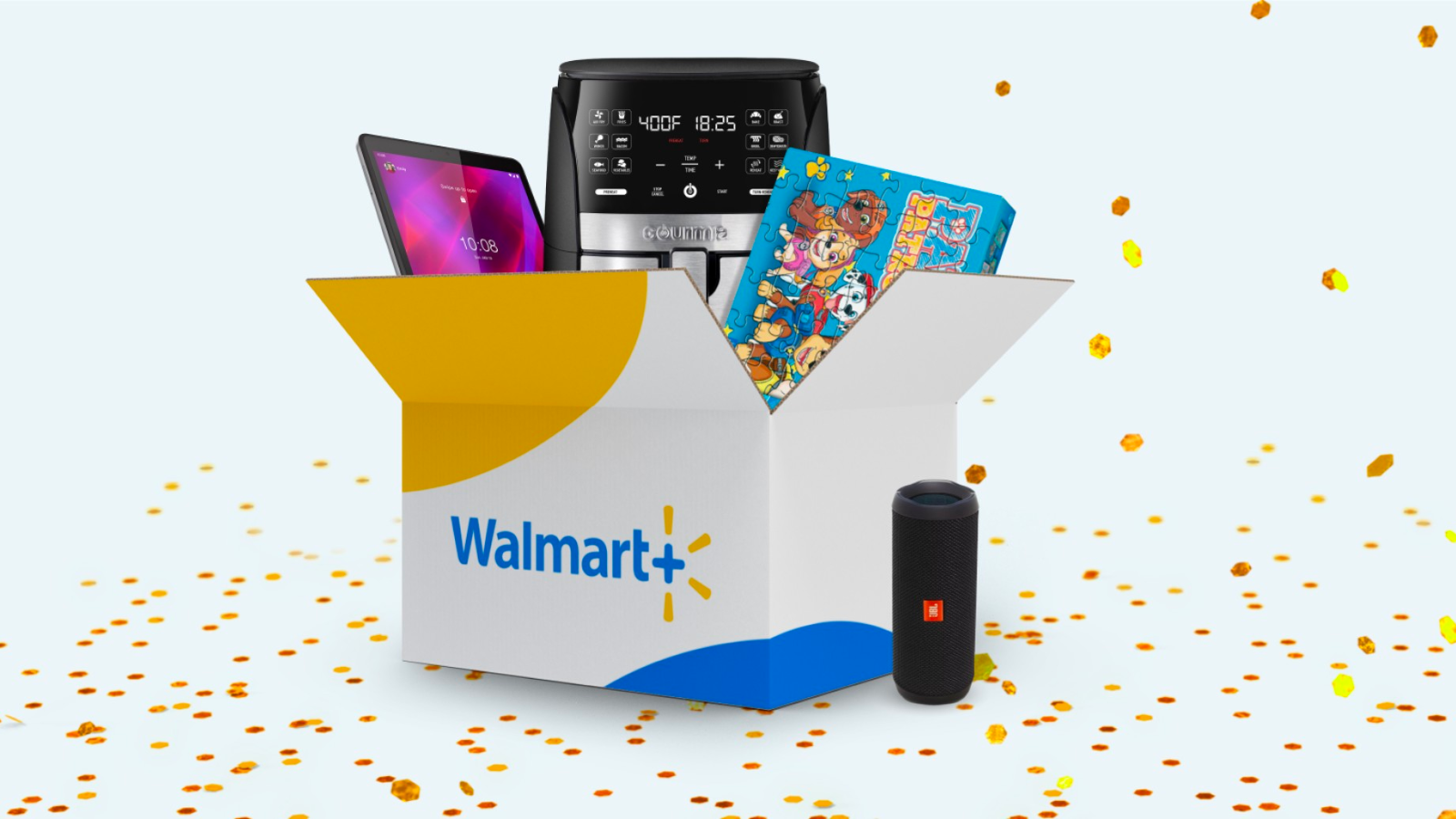 a box with walmart+ branding that contains an air fryer, a tablet, and a puzzle. it sits next to a jbl speaker and is surrounded by confetti