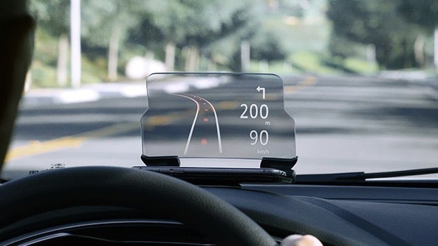 Person driving with the HUDWAY Glass Heads-Up Navigation Display.