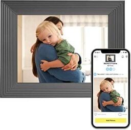 A digital photo frame and a smartphone displaying a young boy and a woman