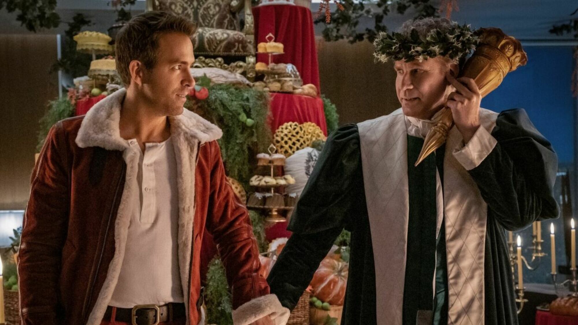 Two men in festive Christmas garb hold hands.