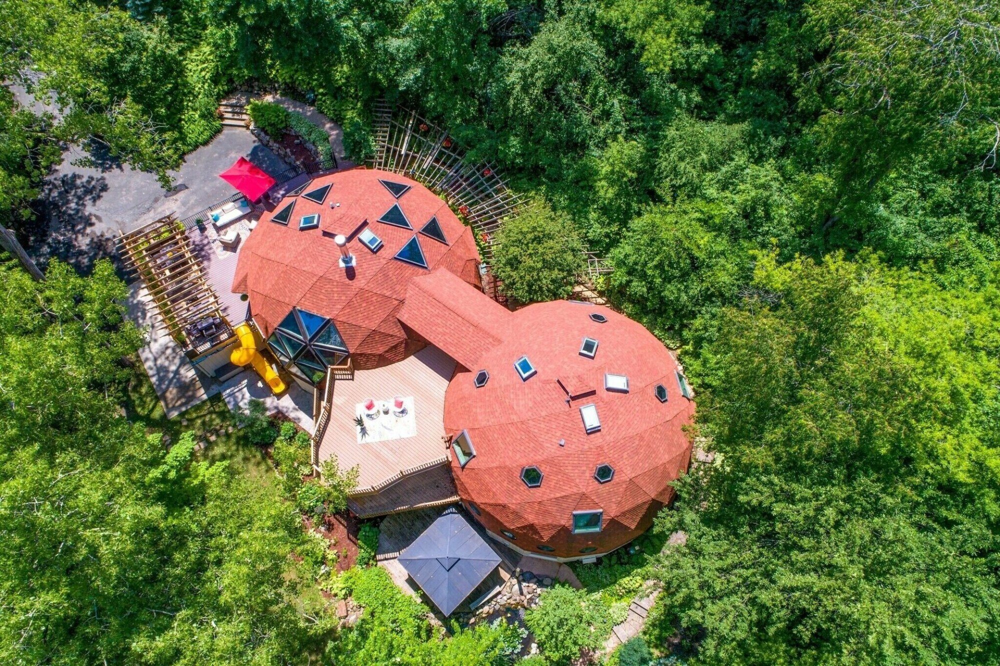 VRBO listing consisting of two geodesic domes connected by a covered path.