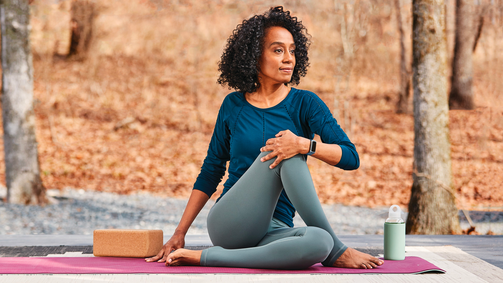 Woman wearing Fitbit Charge 5 in park