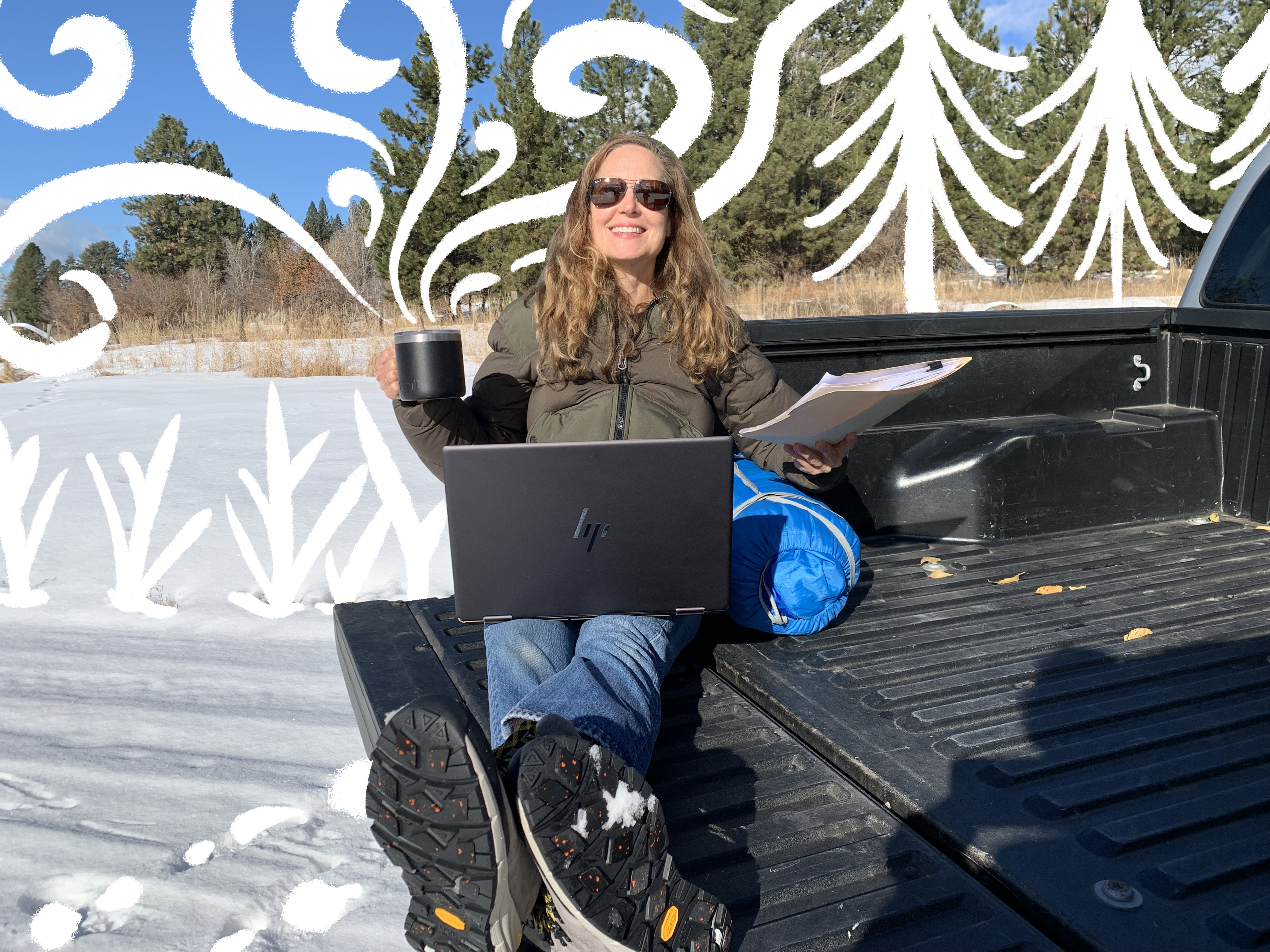 MK sits in the back of a truck using Intel's Arc graphic powered laptop