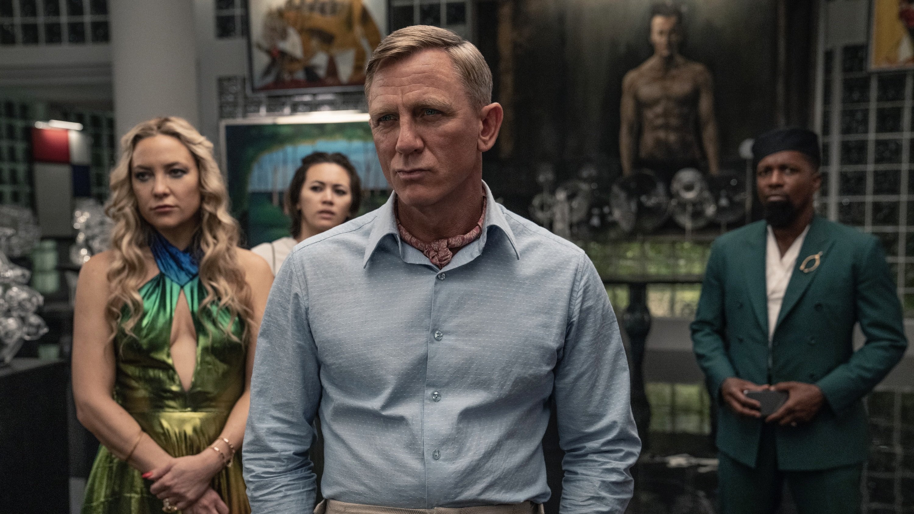 Two men and women stand in a room full of elaborate art.