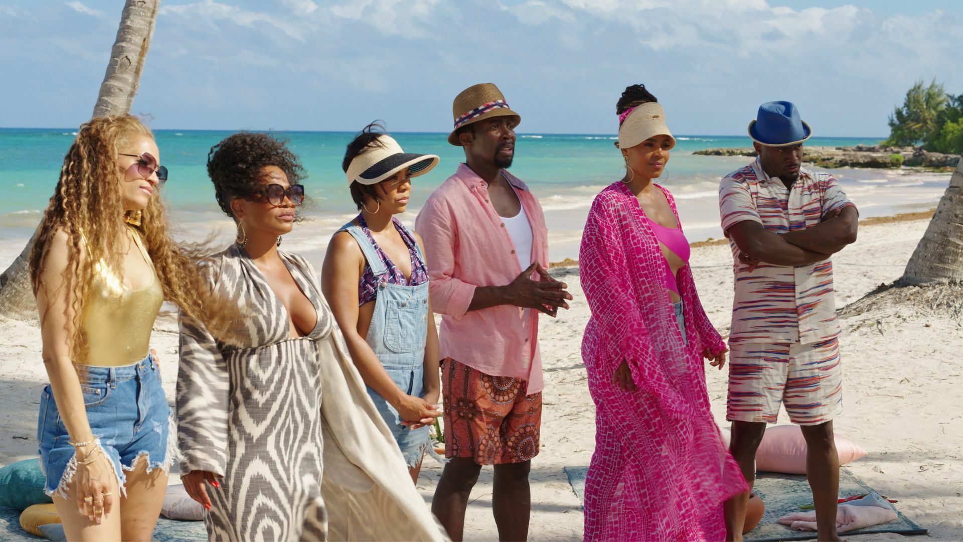 Six Black adults in beachwear on secluded beach