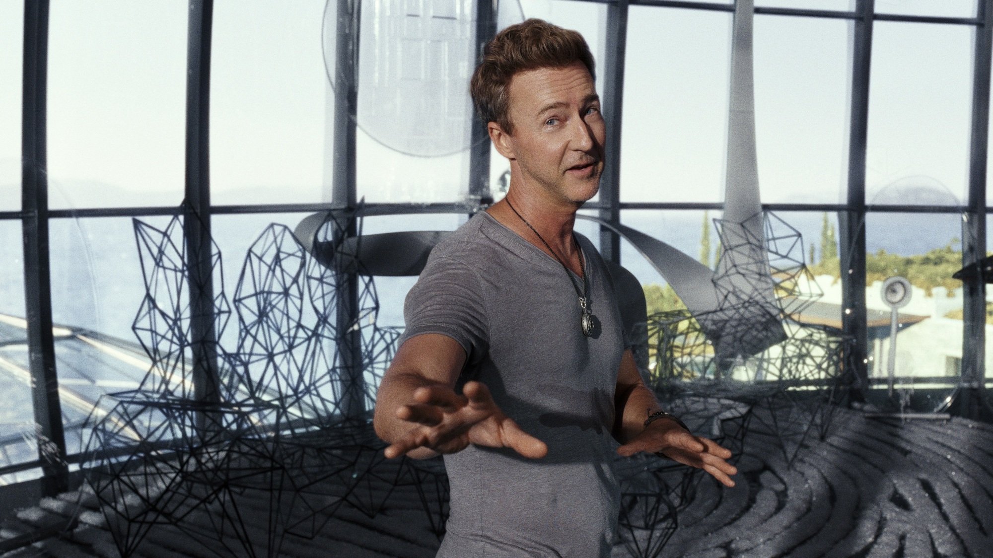 A man in a grey shirt in a glass dome.
