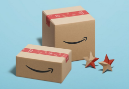 Two cardboard Amazon boxes and stars on blue background