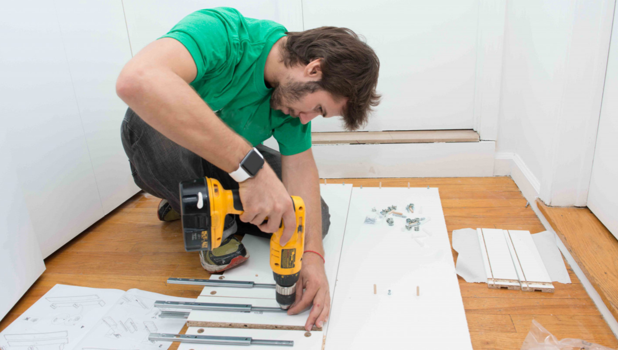 man building ikea furniture