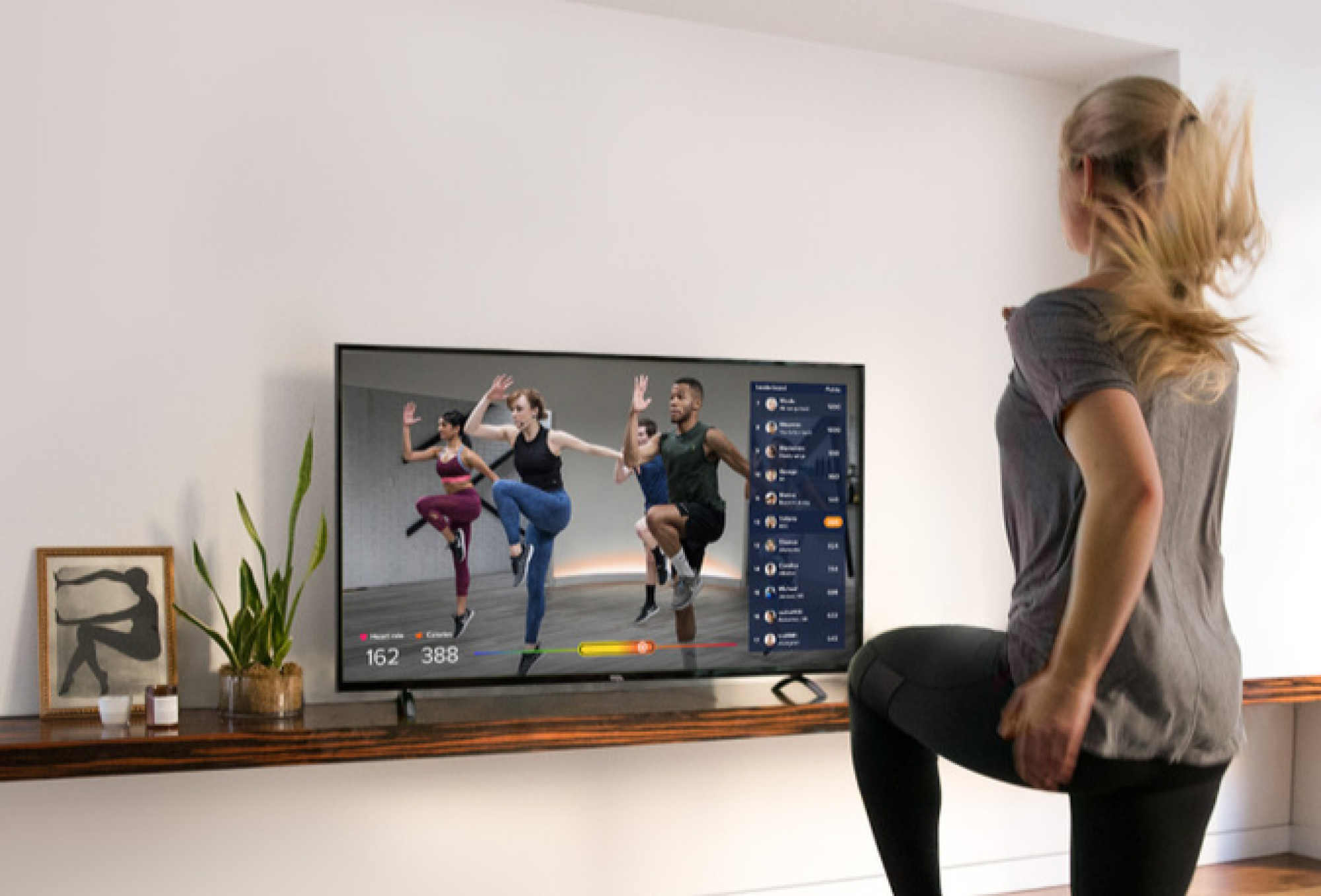 a woman working out to a video in her living room