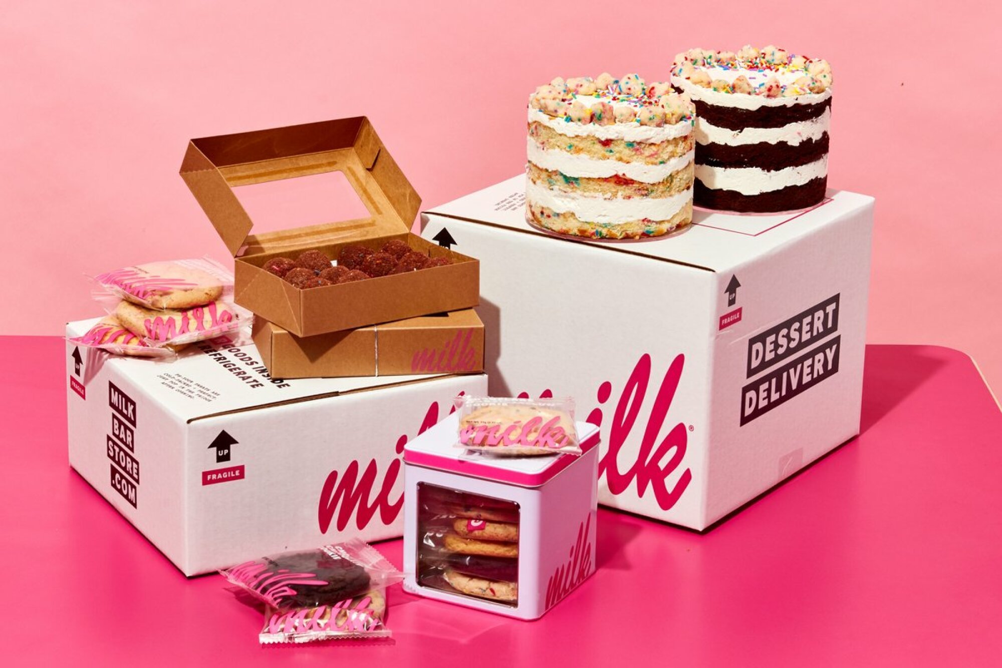 boxes topped with cakes and cookies