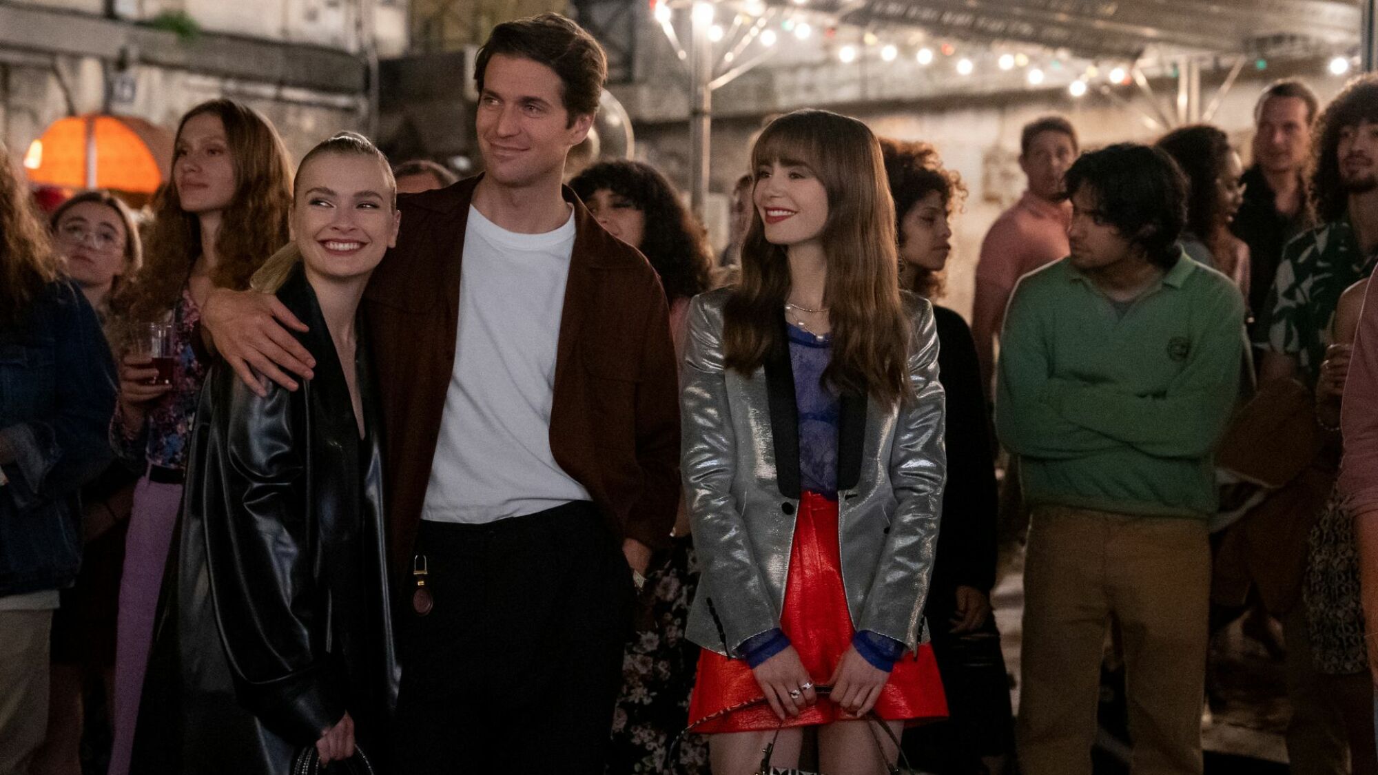 Three white millennial-aged friends watching happily in the distance
