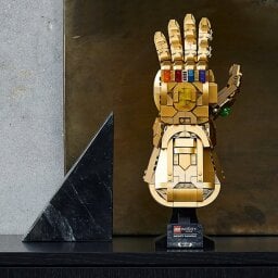 A golden gauntlet lying on top of a stand.