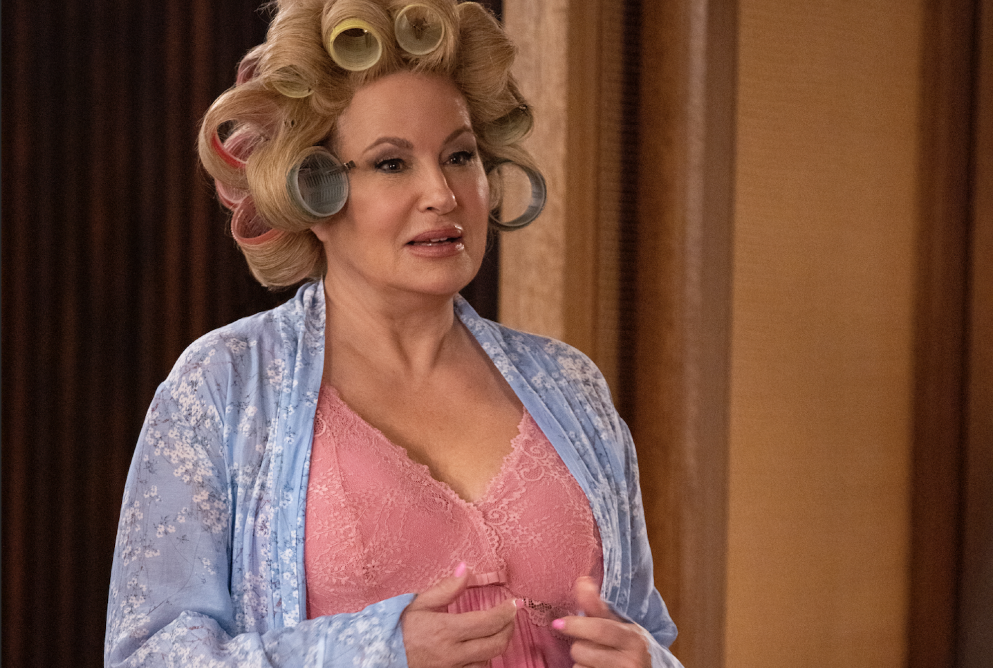 Jennifer Coolidge, a white blonde woman with her hair in curlers.