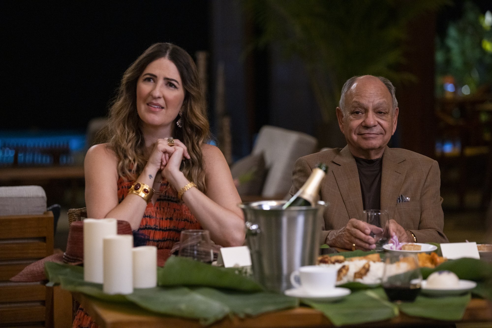D'Arcy Carden and Cheech Marin sit at a table.