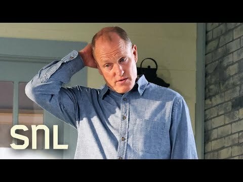 Balding Woody Harrelson in blue button up