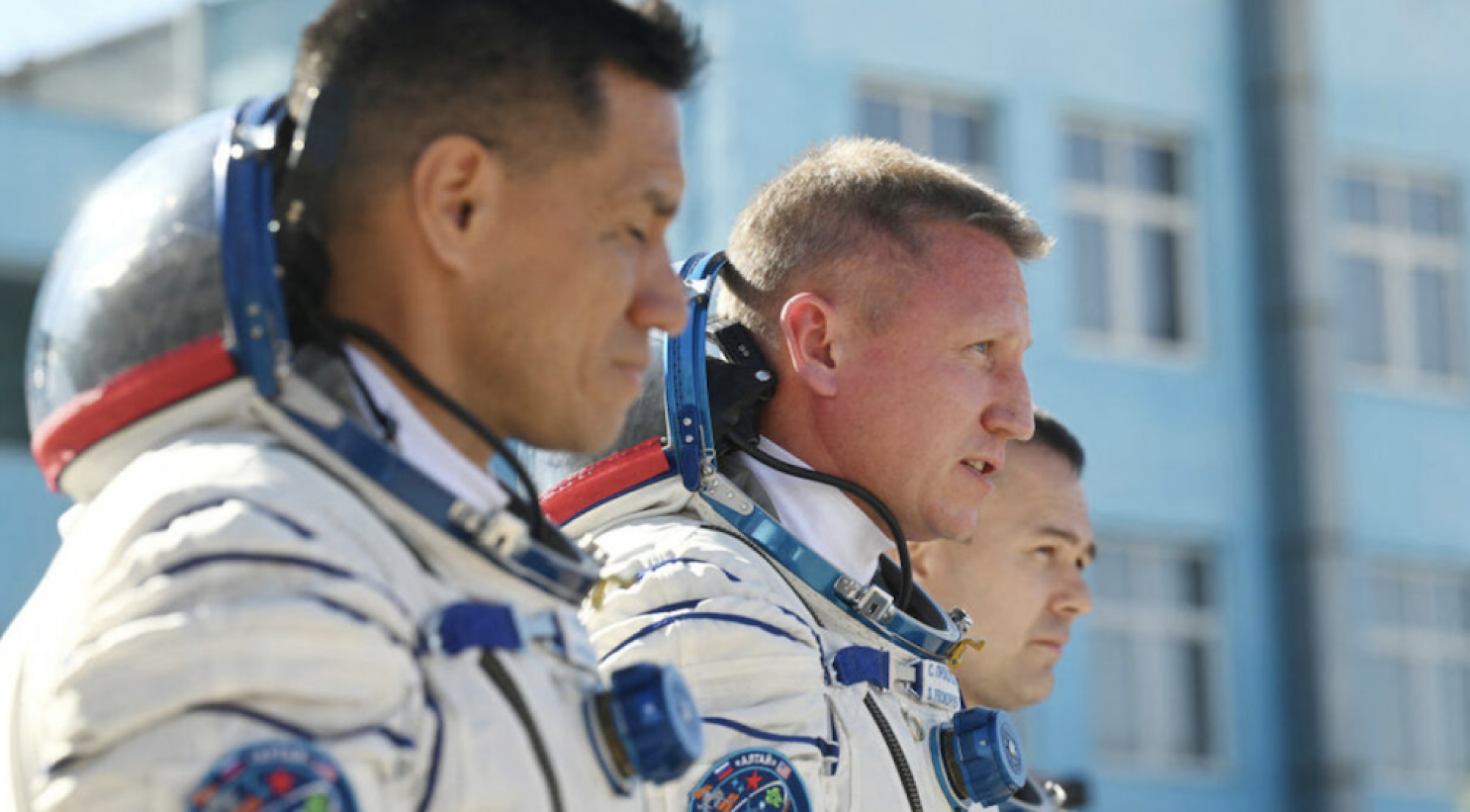 Three marooned space station crew members walking