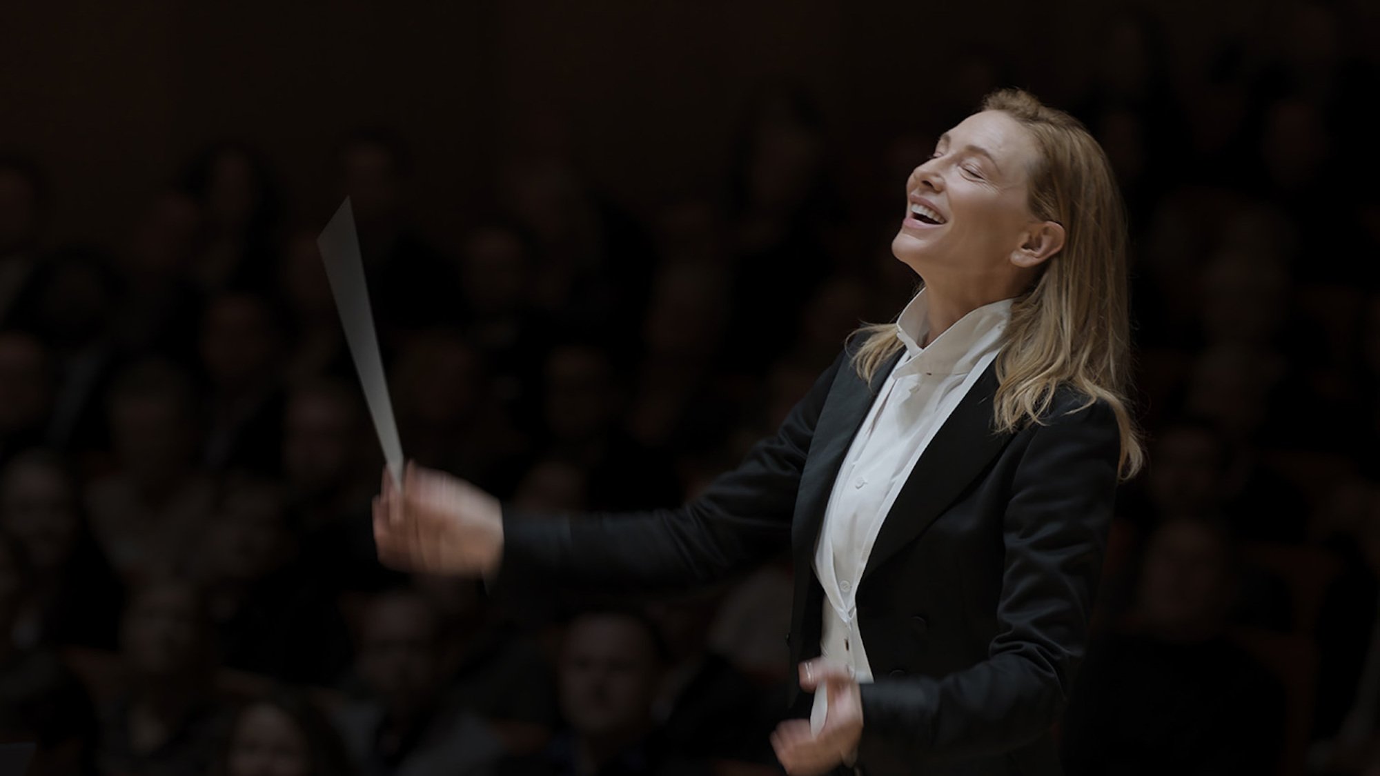 A composer smiles in mid-performance bliss.