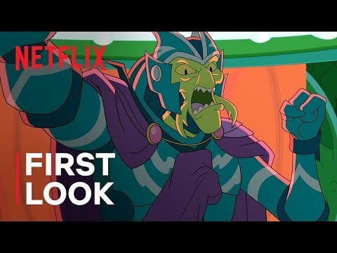 A green alien in purple armor.
