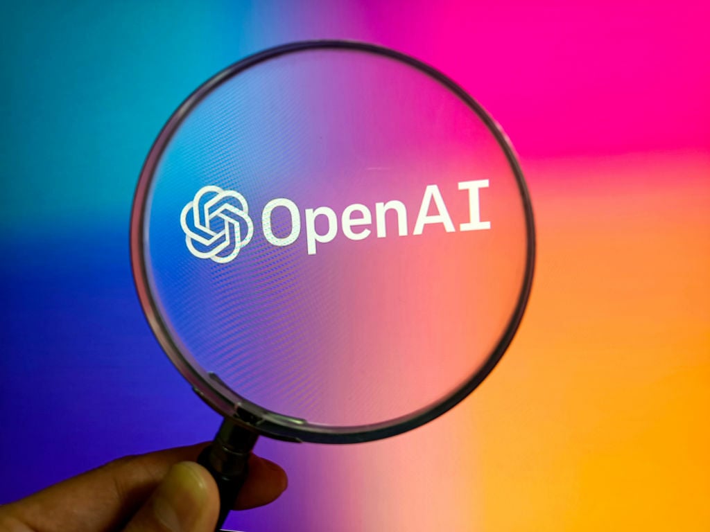 Magnifying glass over the OpenAI logo