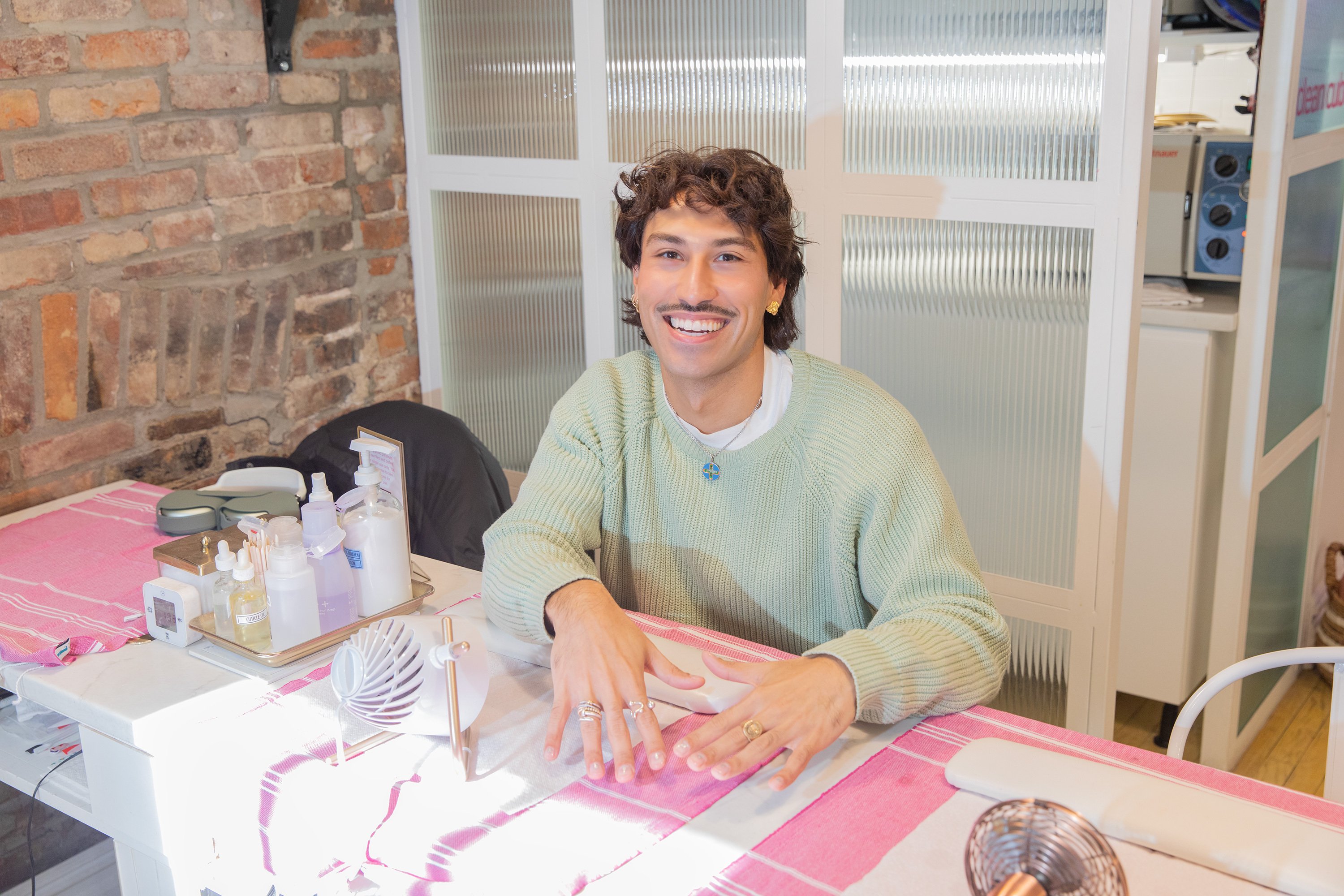 Erico Sedeno at nail salon with manicure