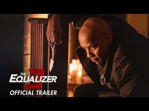 Denzel Washington as Robert McCall kneeling down with a knife.