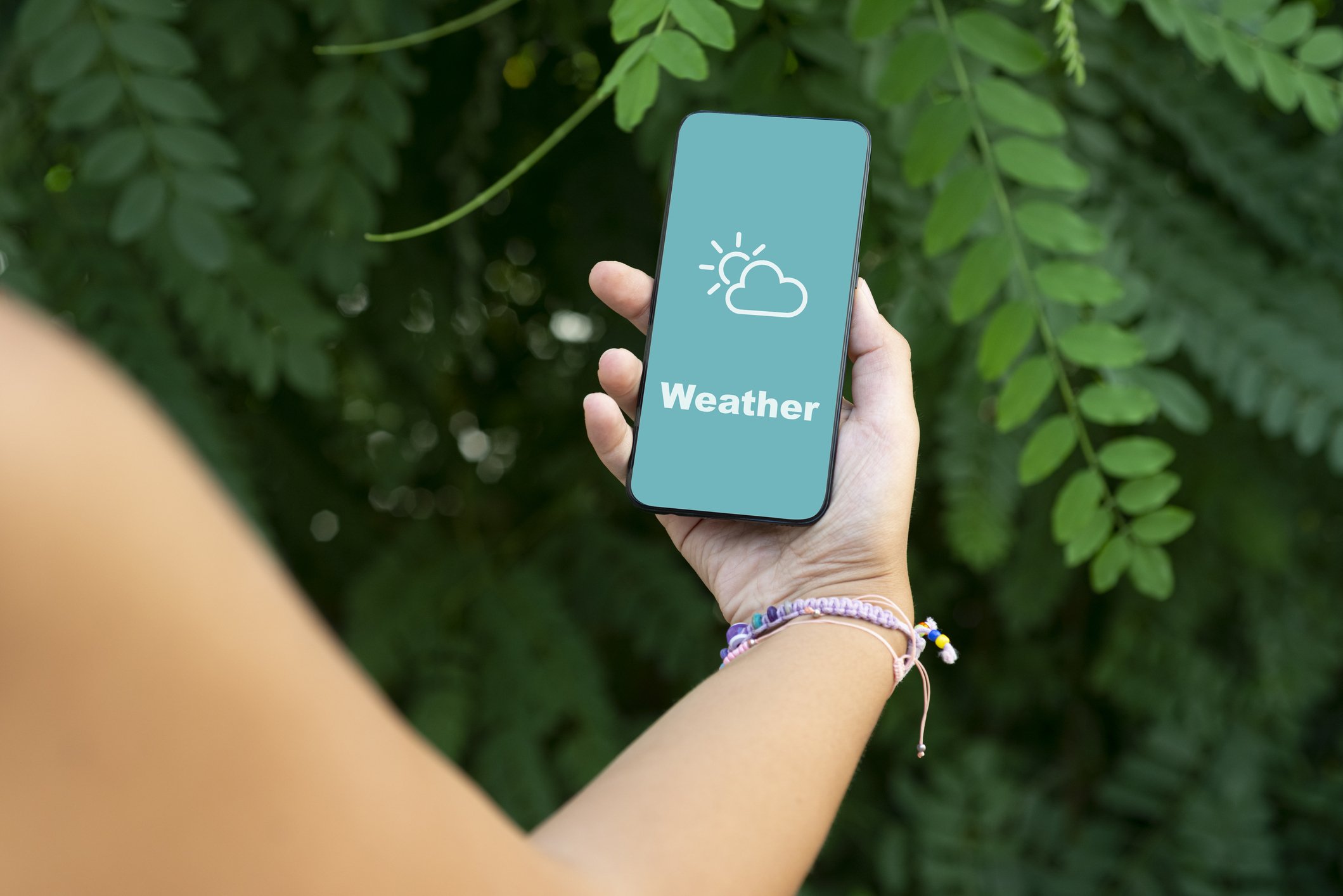 Woman checking the weather on a smartphone