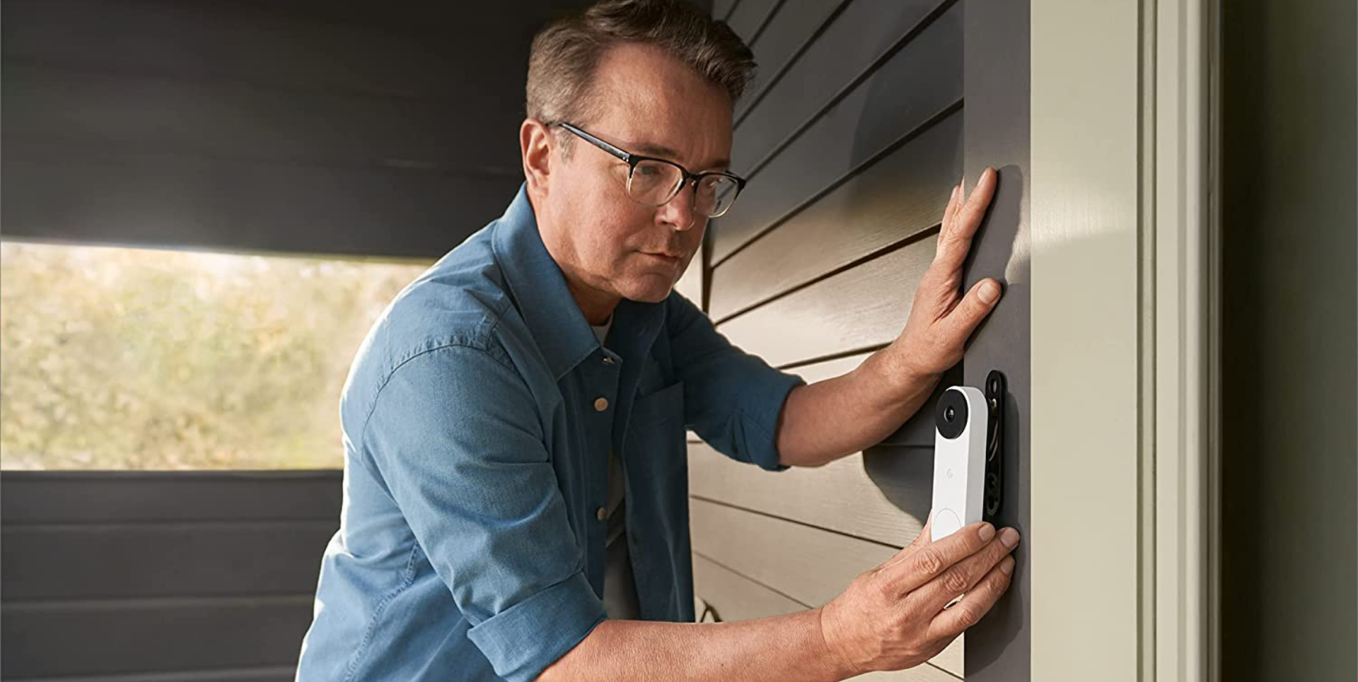 Man installing a Google nest security doorbell