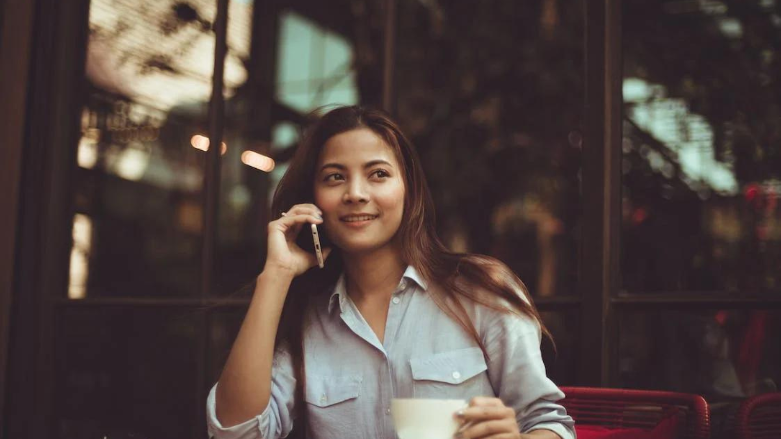 woman talking on phone in coffee shop