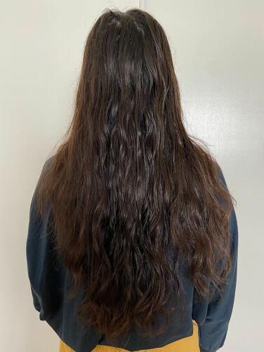 woman facing away from photo with wavy damp hair