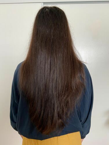 back of woman's head with straightened styled hair