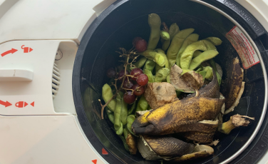 Lomi composter bucket filled with fruit and edamame