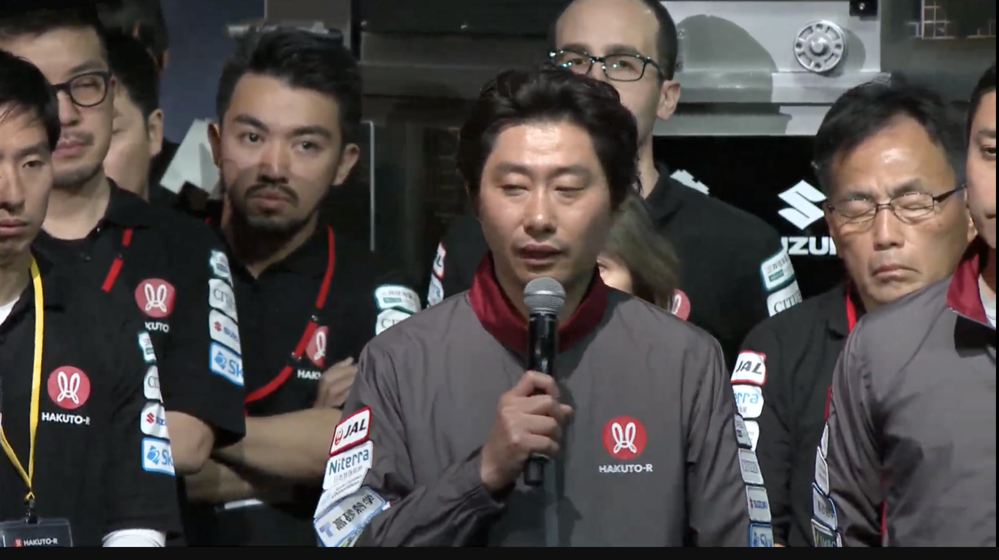 Takeshi Hakamada addressing the crowd after moon landing attempt