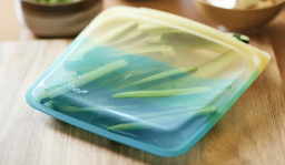 blue and yellow stasher bag with chopped cucumbers inside