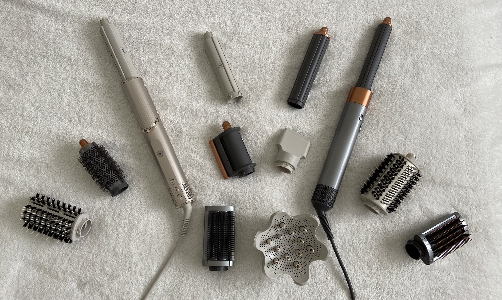 dyson airwrap and shark flex style tools laid out in an arch