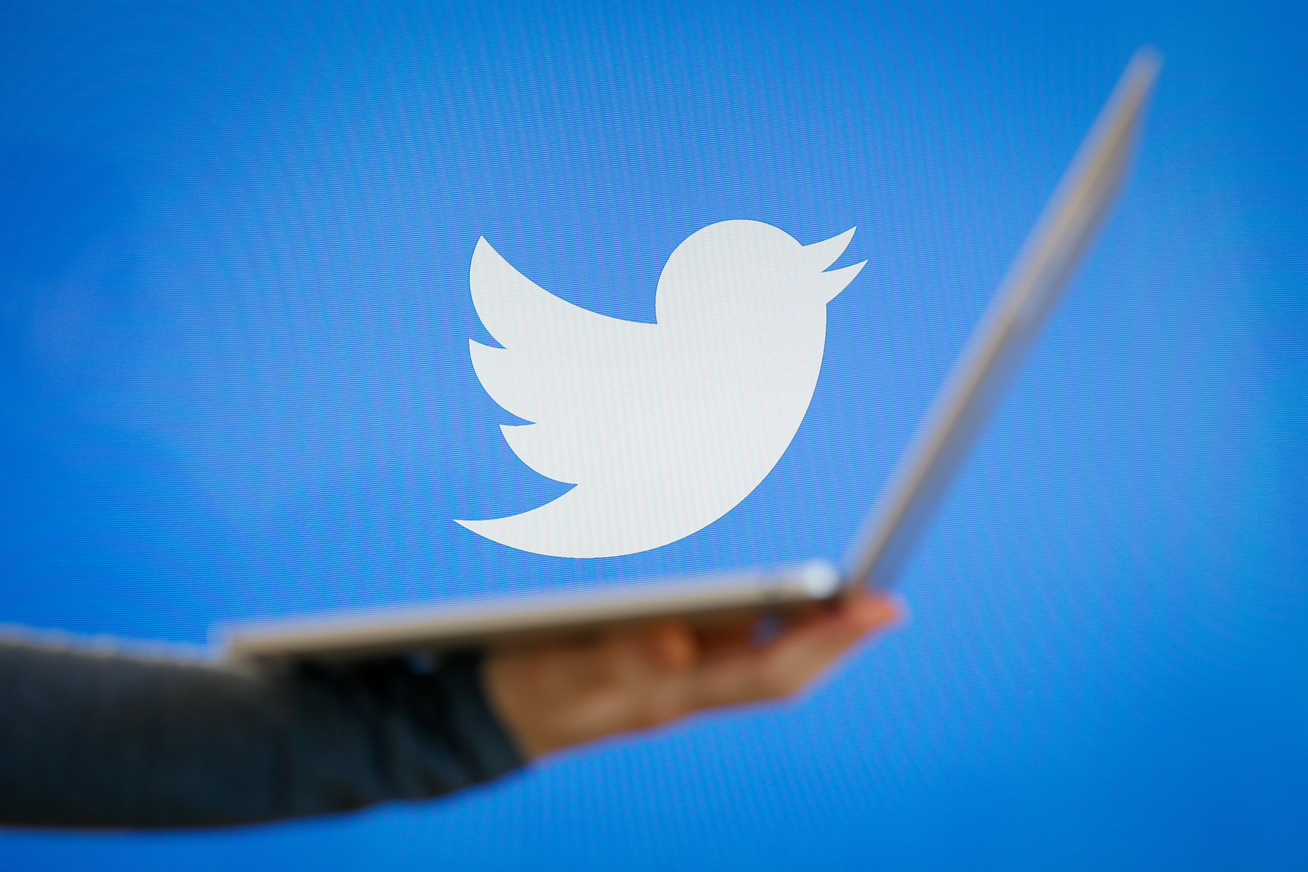 Twitter logo next to laptop