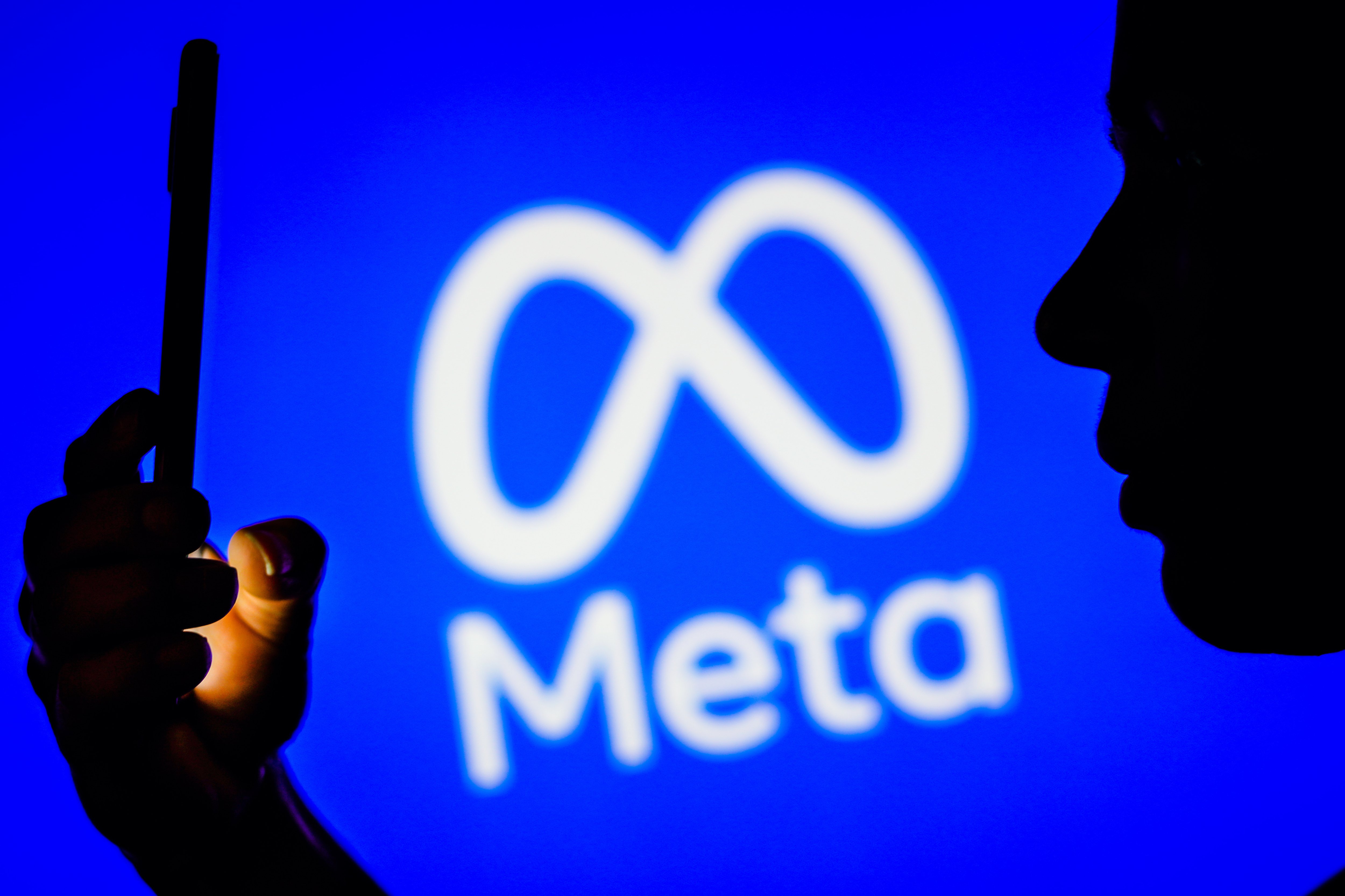 Meta logo with user on mobile device