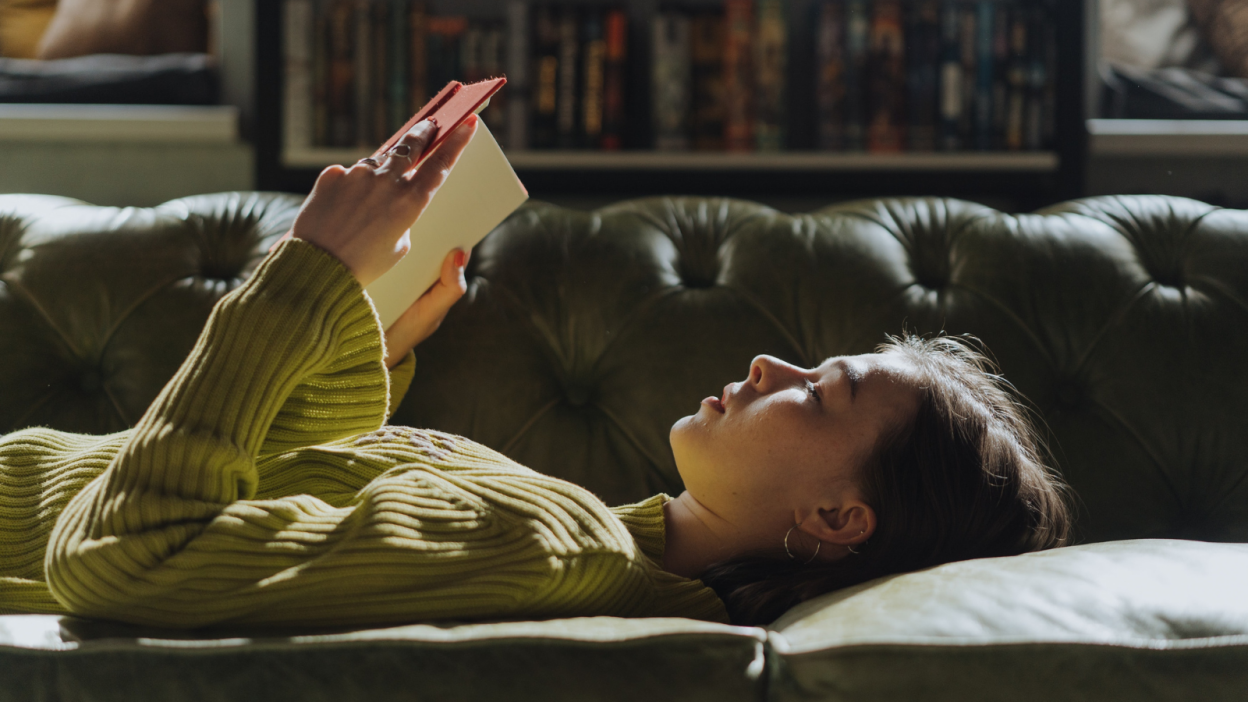 Girl lying down reading book