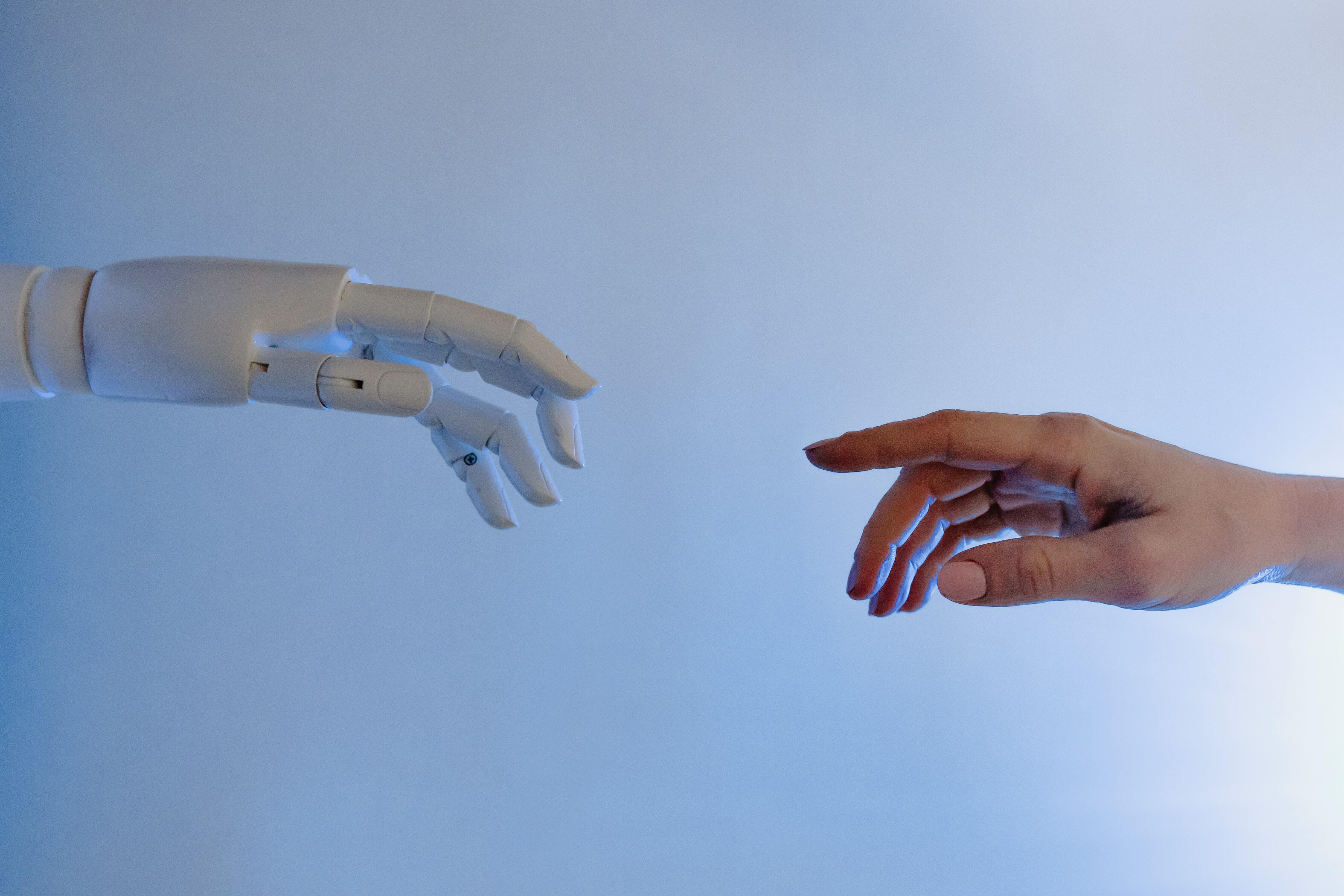 Human hand reaching out for robot hand