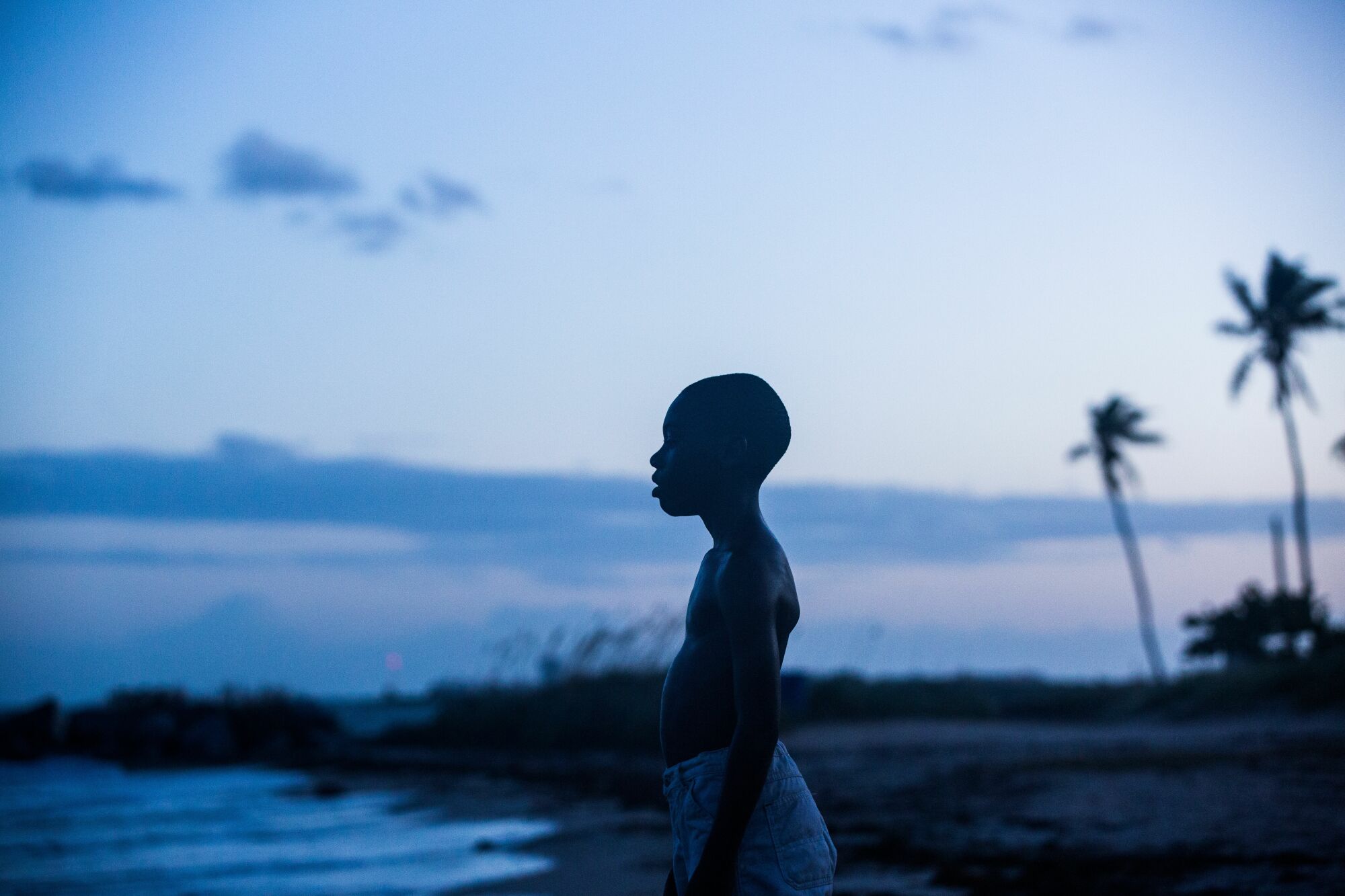 Alex R. Hibbert stands on a beach in "Moonlight."