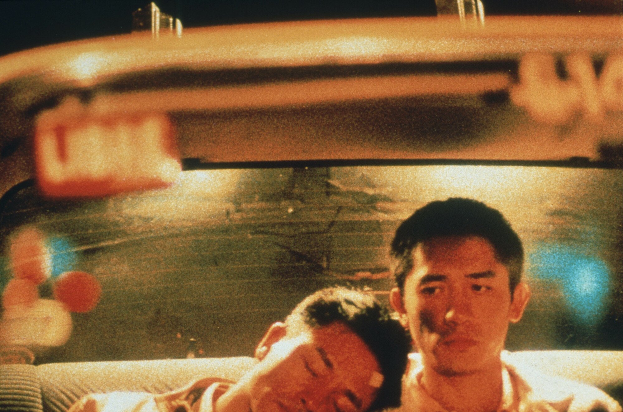 Tony Leung and Leslie Cheung ride in the back of a cab in "Happy Together."