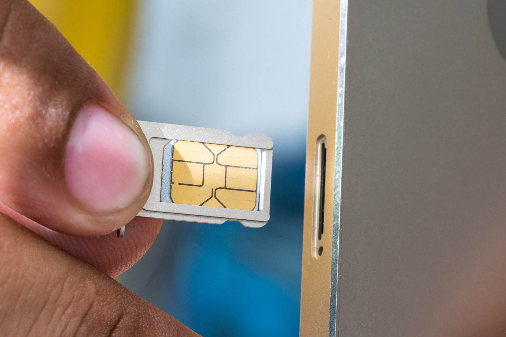 A SIM card being inserted into a phone.